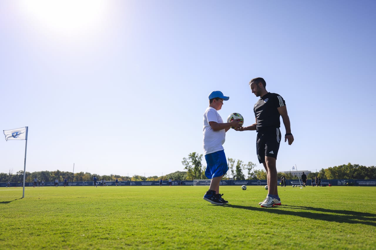 Miles Smith and Sporting Kc's Project Management Specialist Sam Kovzan play pitch side during training on Oct. 3.