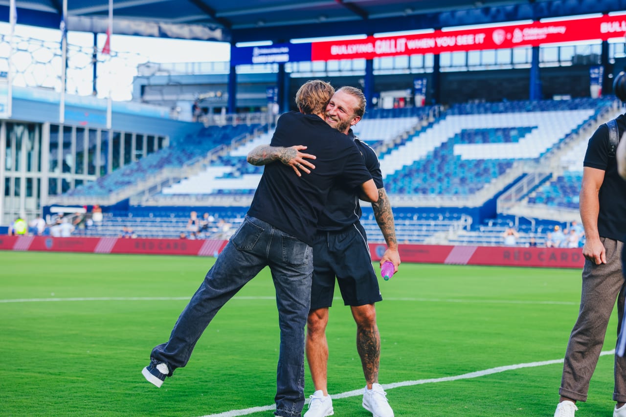 Real Salt Lake forward Johnny Russell hugs Sporting KC midfielder Jake Davis.