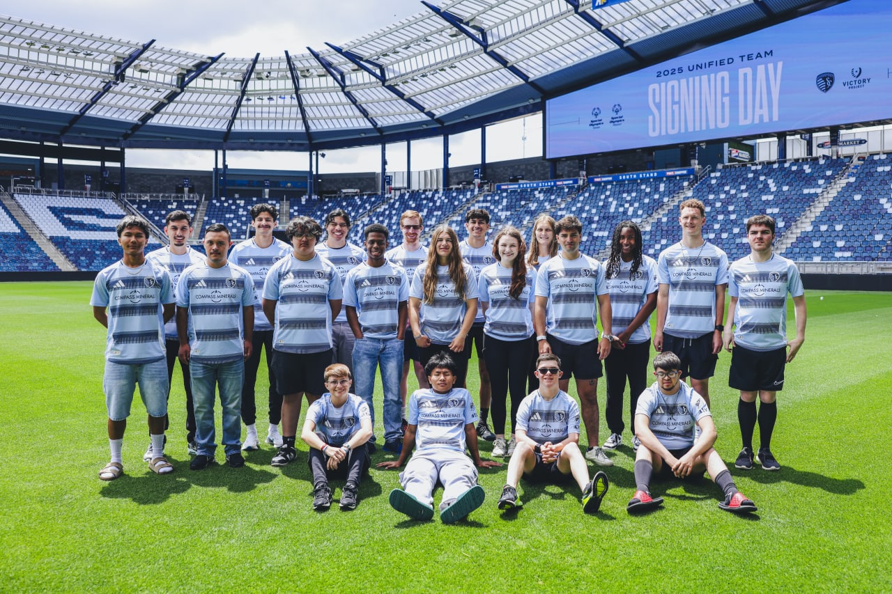 Unified team poses for a team photo at Children's Mercy Park on signing day.
