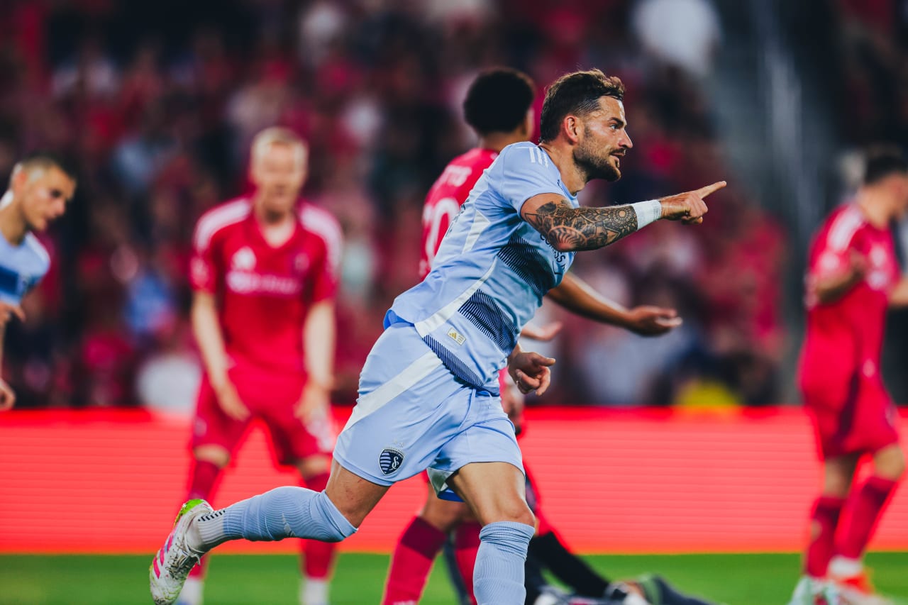 Sporting KC defender Tim Leibold points to Daniel Salloi after receiving the assist