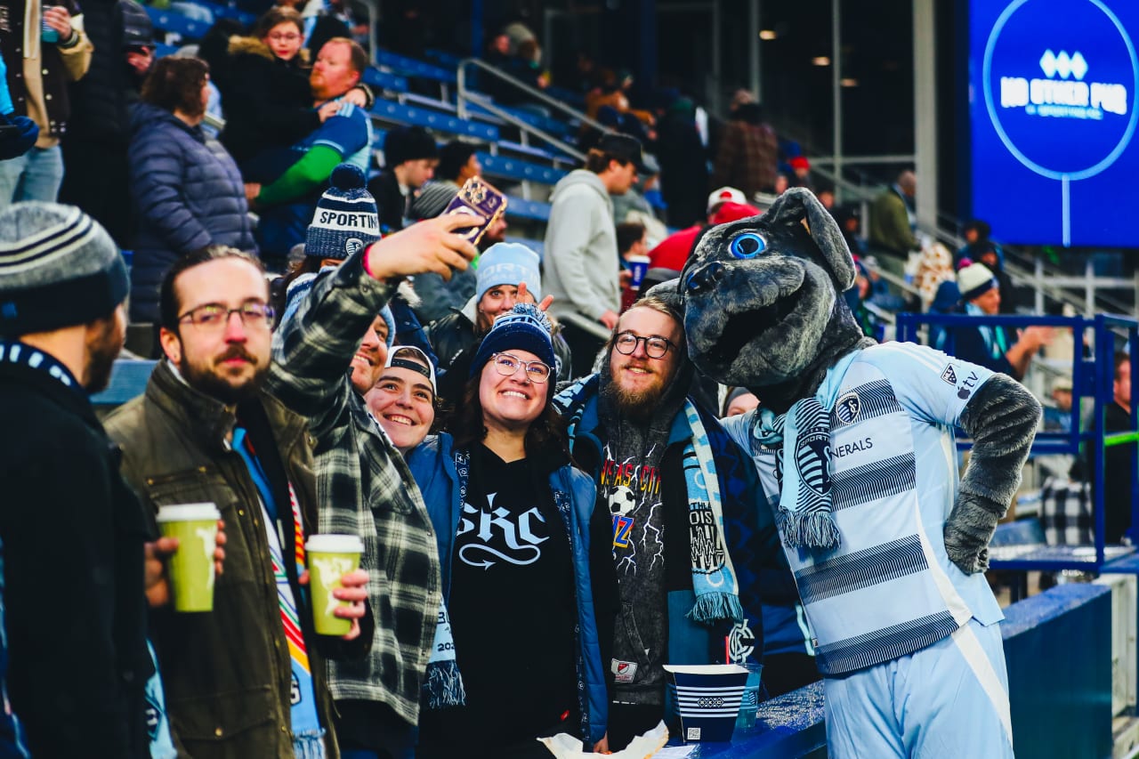 Blue poses with a group of Sporting KC fans.