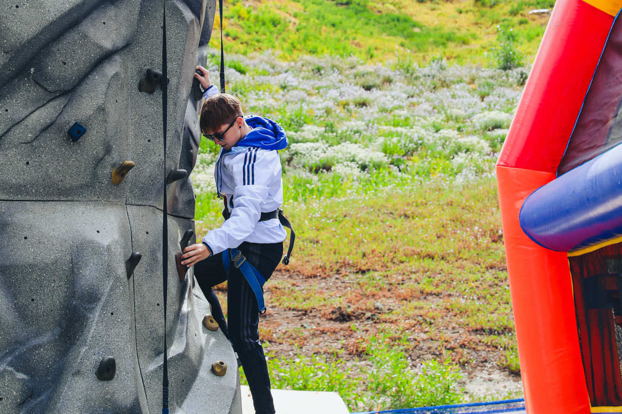 Kaylee Baggerly climbs a rock wall while on the team outing in Salt Lake.