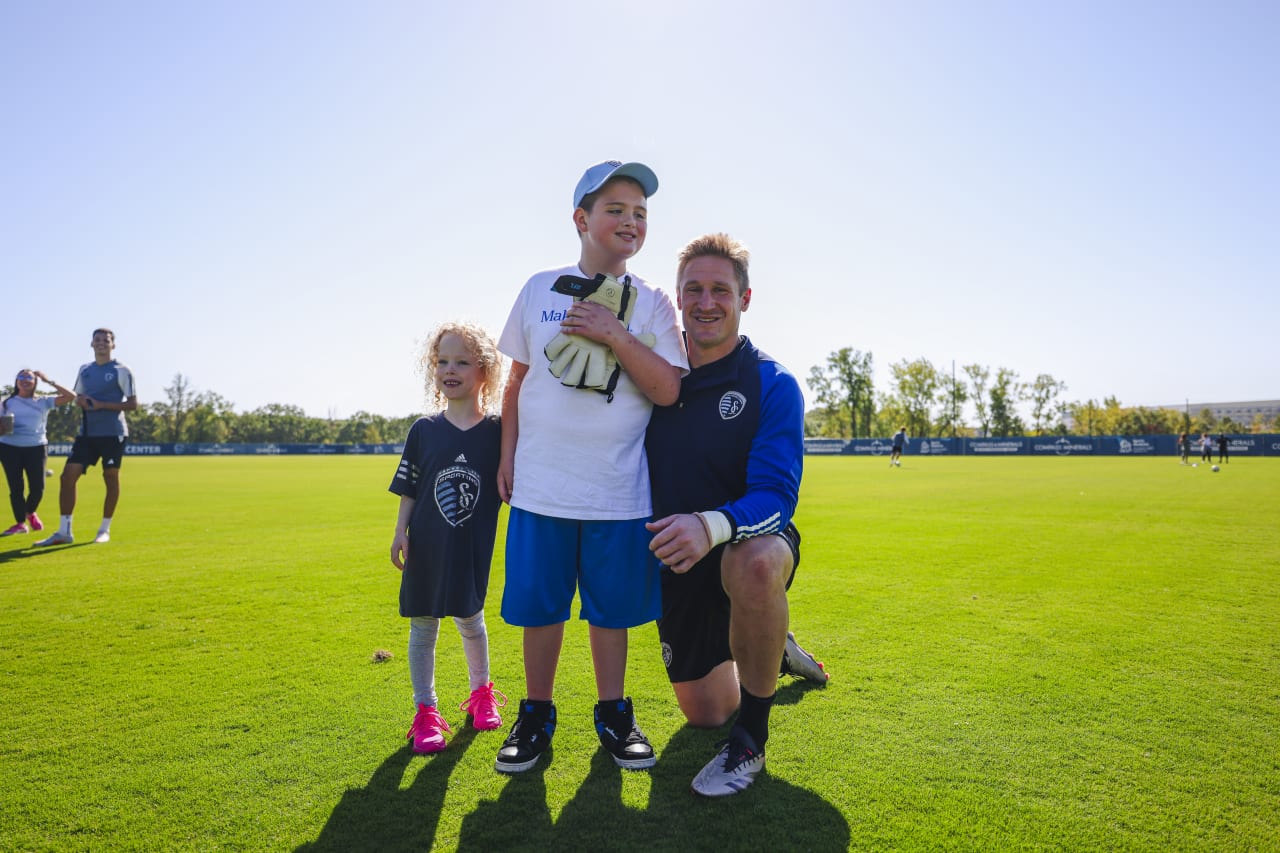 Miles Smith takes a picture with Goalkeeper Tim Melia, after Melia gifts him his keeper gloves.